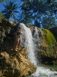 Scenic view of waterfall amidst rocks