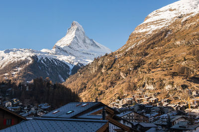 Scenic view of snowcapped mountains against clear sky