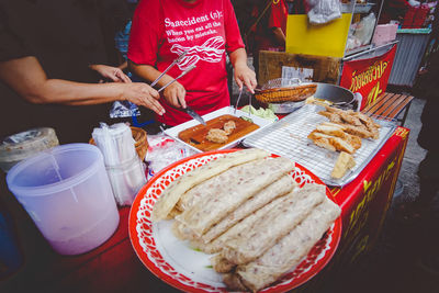 High angle view of people preparing food on table