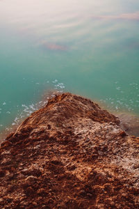 High angle view of rocks by sea against sky