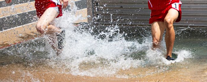 Low section of man running on water