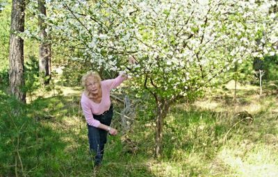 Full length of smiling girl standing on land