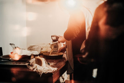 Midsection of man preparing foo in kitchen