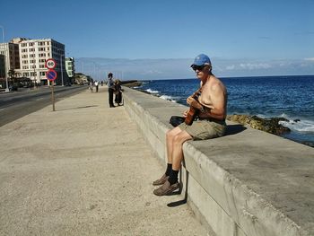Man on beach against clear sky