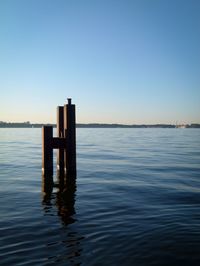 Wooden posts in sea