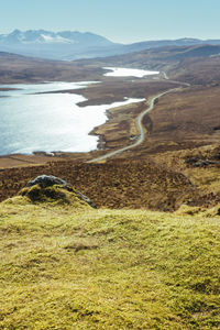 Scenic view of land and sea against sky