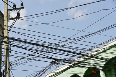 Low angle view of electricity pylon against sky