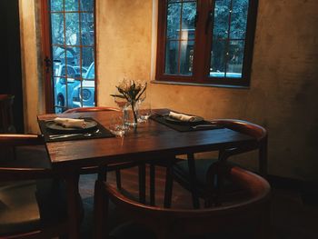 Empty chairs and table in room