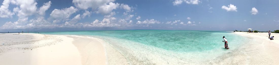 Panoramic view of beach against cloudy sky