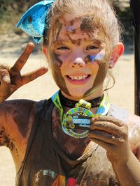 Portrait of smiling boy holding camera