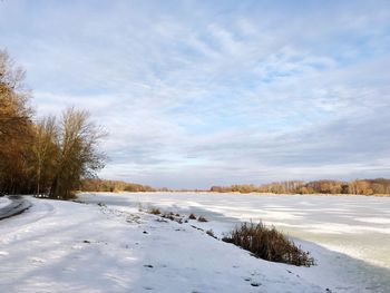 Snow covered field against sky