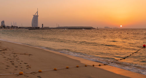 Scenic view of beach against sky during sunset