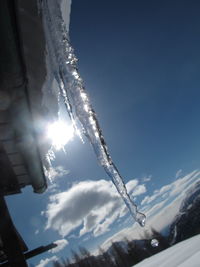 Low angle view of snow covered mountain against sky