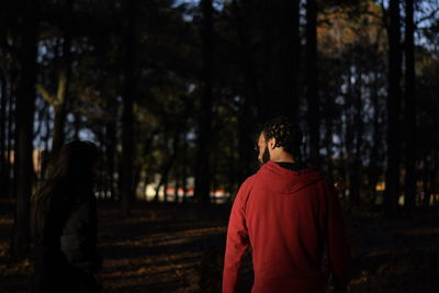 Rear view of man walking in forest