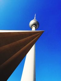 Low angle view of communication tower against blue sky