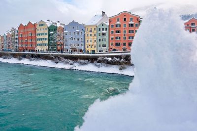 River flowing through city in winter