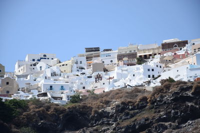 Low angle view of buildings against clear blue sky