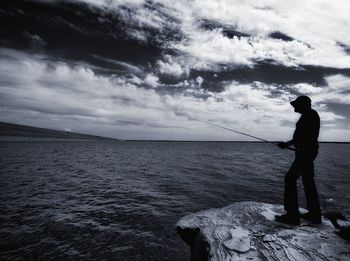 Man standing on beach against sky