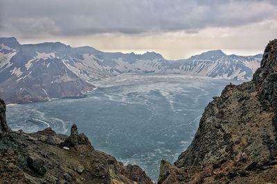 Scenic view of mountains against cloudy sky