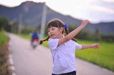 Smiling girl standing outdoors