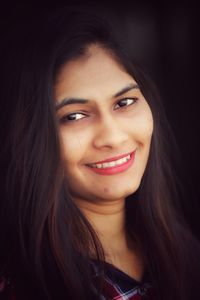 Close-up portrait of a smiling young woman