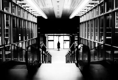 People walking in corridor of building