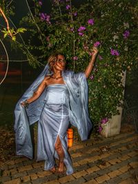 Portrait of woman standing against plants