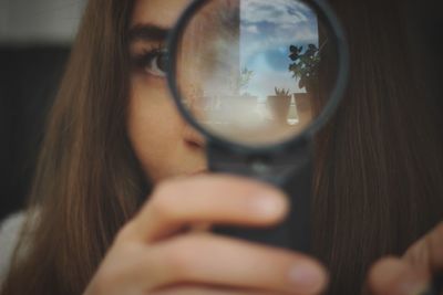 Close-up portrait of woman photographing through smart phone