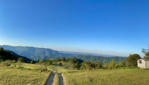 Scenic view of landscape against clear blue sky