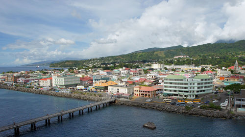 Scenic view of river by town against sky