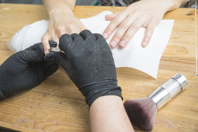 Midsection of woman working on wooden table