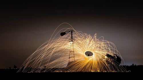 Firework display against sky at night
