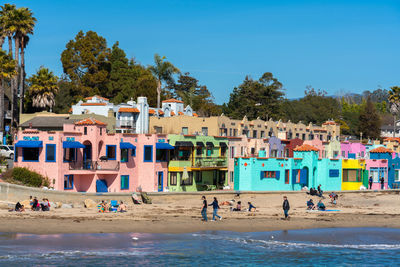 Group of people on beach against sky