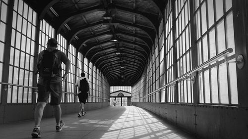 Rear view of women walking in corridor