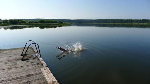 Low section of person diving into lake
