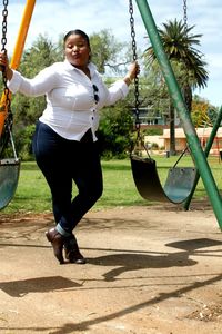 Full length of boy on swing at playground