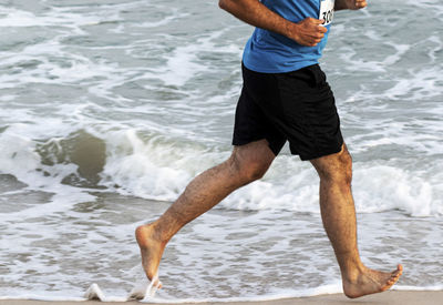 Rear view of man standing on beach