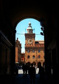 People in front of clock tower