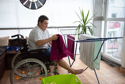 Portrait of young woman sitting on wheelchair