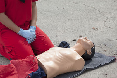 Midsection of woman by cpr dummy