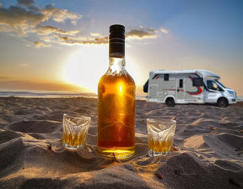 Close-up of bottles on beach
