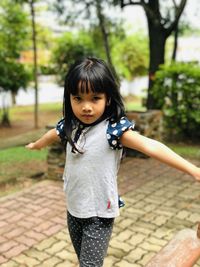 Portrait of a girl smiling on footpath