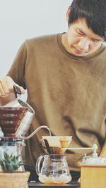 Man preparing drink at table