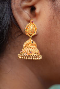 Gold jimikki kammal earrings on indian girl ears. designed earrings stock images.