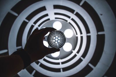 Close-up of man sphere against lighting equipment