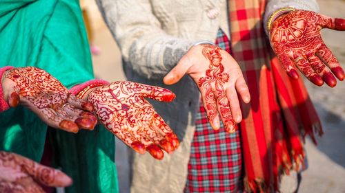 Close-up of women showing henna tattoo