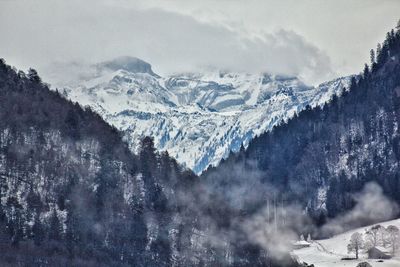 Scenic view of snowcapped mountains against sky