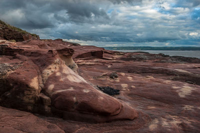 Scenic view of sea against dramatic sky