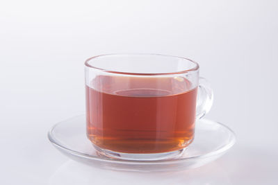 Close-up of tea in glass against white background