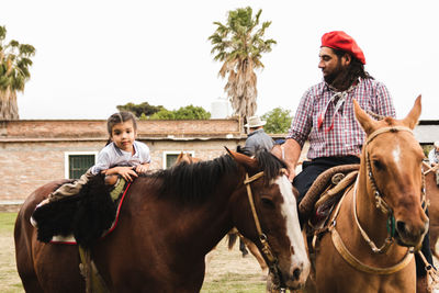Portrait of south american family riding horses